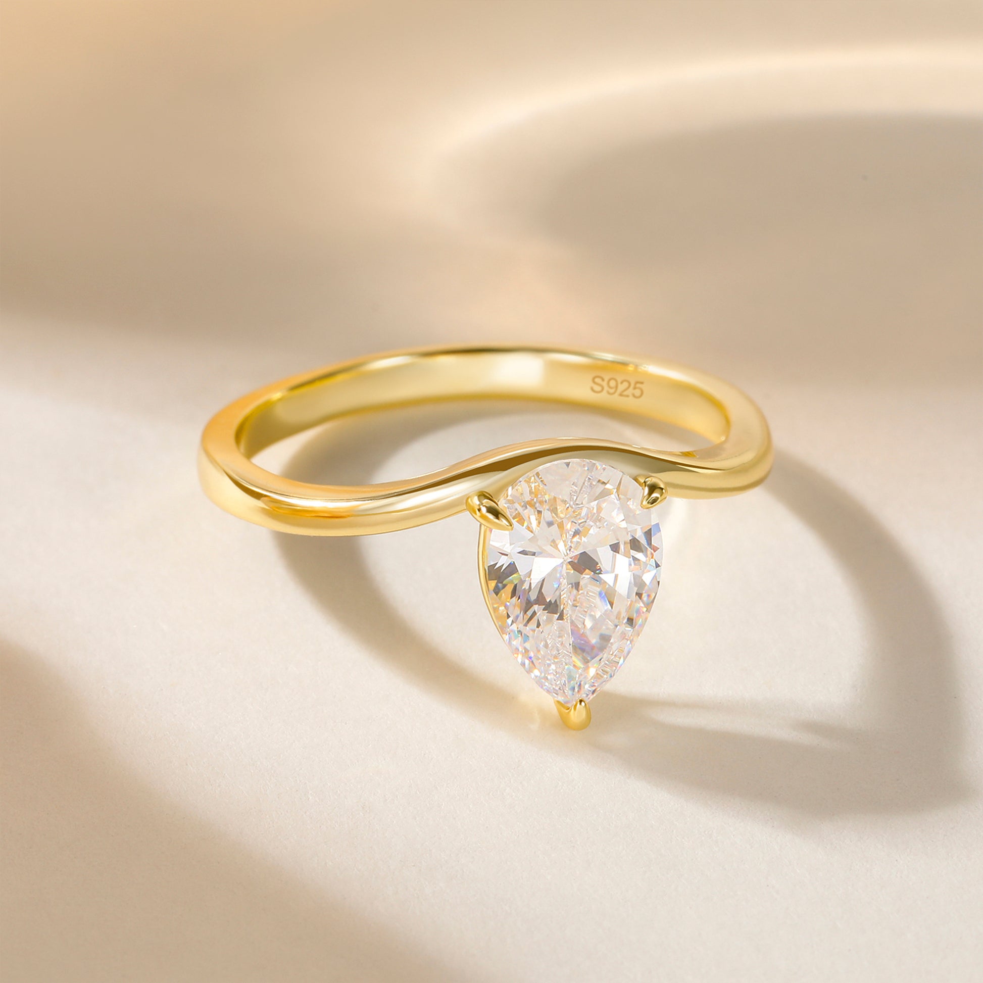 curved engagement rings, curved band, pear engagement rings, pear cut, cubic zirconia rings, cubic zirconia usa, travel rings, fake diamond rings, cz rings, affordable jewelry, gold engagement rings