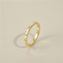 minimalist wedding band ring, 5A CZ band ring, modern promise ring, cubic zirconia Rings, cz ring, wedding rings cz, eamti rings, cheap wedding rings under $50, copper ring,stackable ring. Gold ring with small diamonds on a beige background